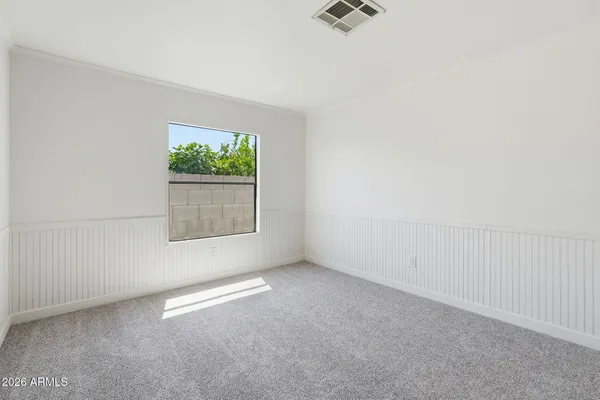 a view of a livingroom with a ceiling fan and entryway