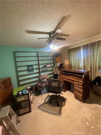 a room with furniture and a ceiling fan
