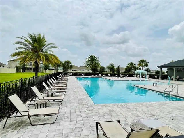 an outdoor space with swimming pool and furniture