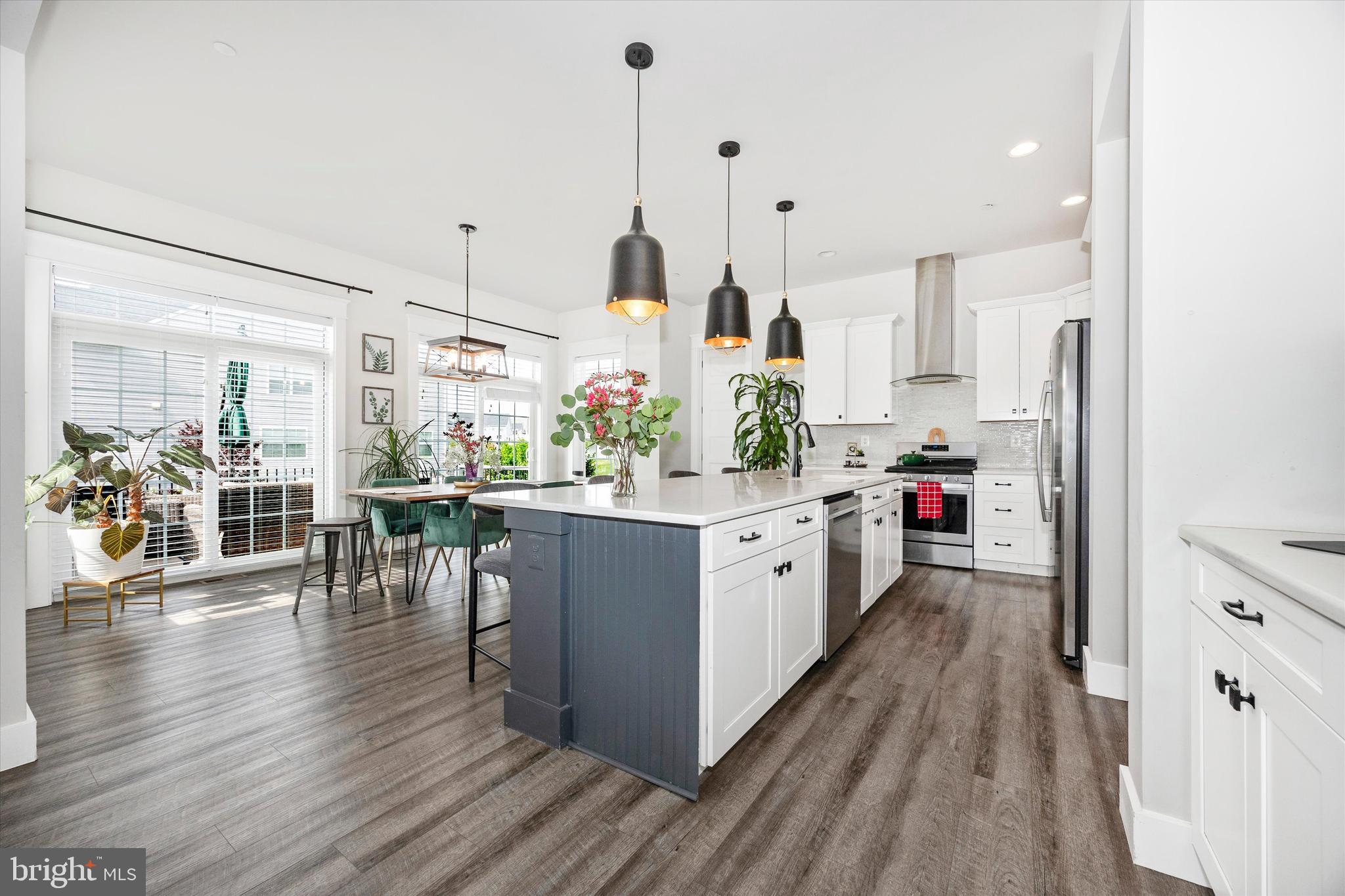1694 Double Bank Road Frederick, MD 21702 - Photo 11 of 79 a kitchen with stainless steel appliances kitchen island sink stove and wooden floor