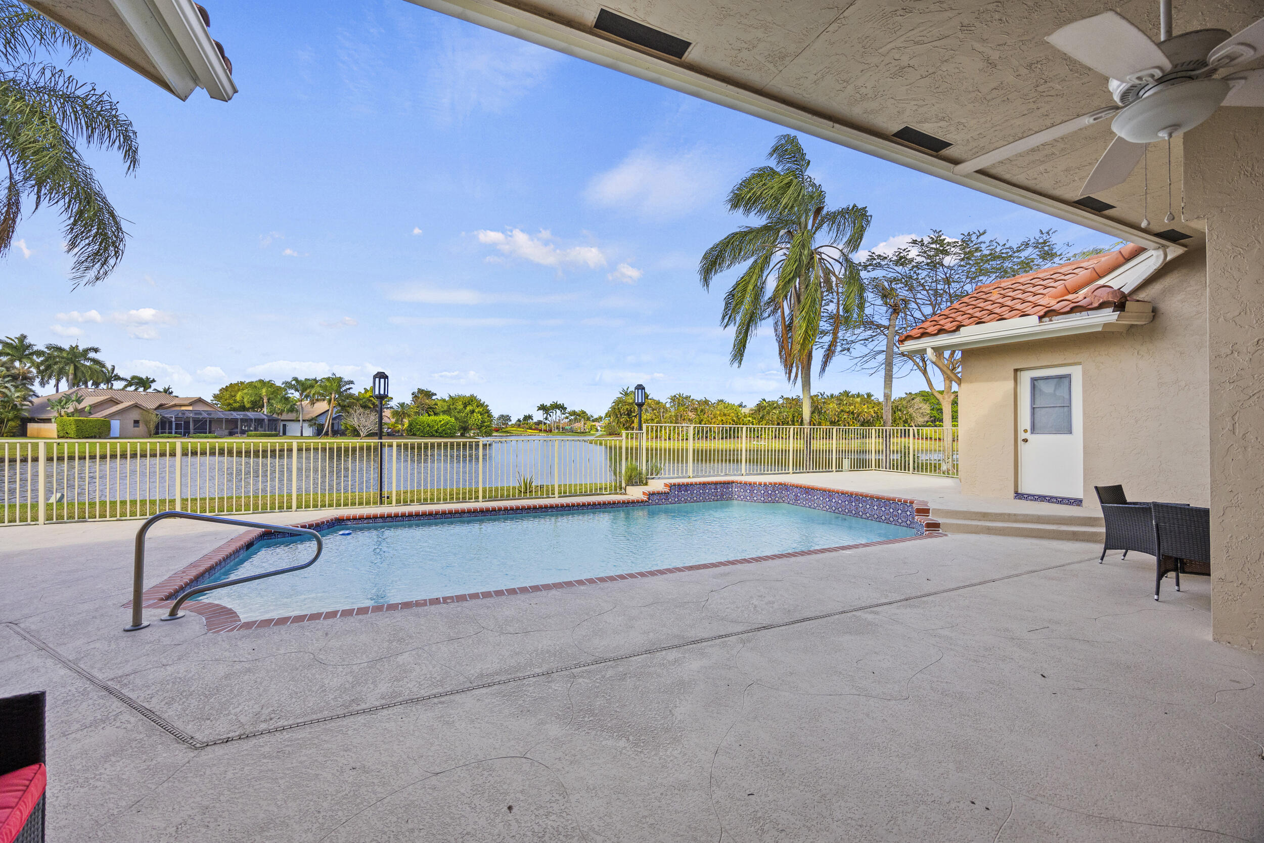 10747 Stonebridge Boulevard Boca Raton, FL 33498 - Photo 45 of 75 a view of a swimming pool with a lounge chairs