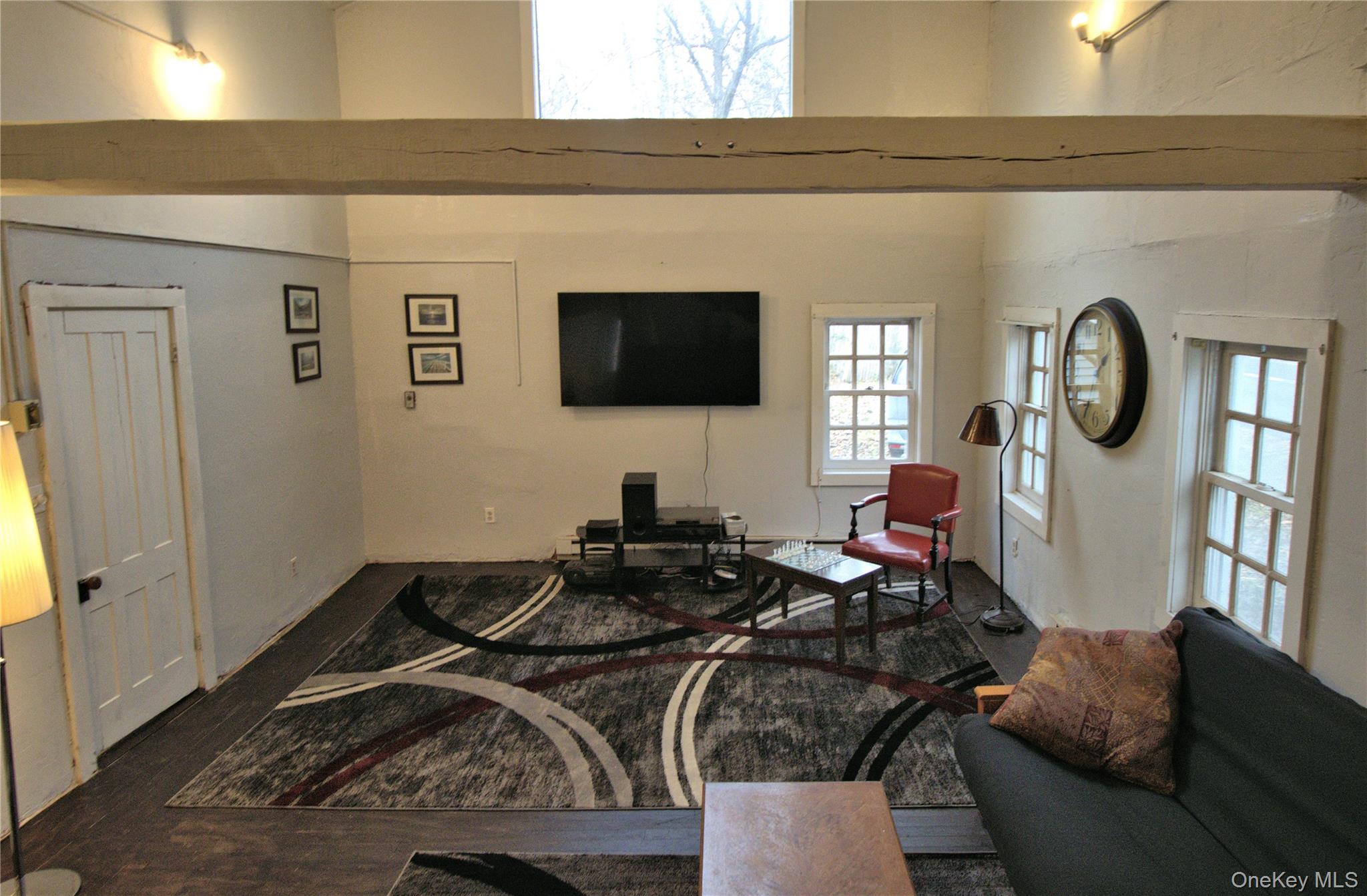 7 State Rte 55 Napanoch, NY 12458 - Photo 2 of 38 a living room with furniture a flat screen tv and a window