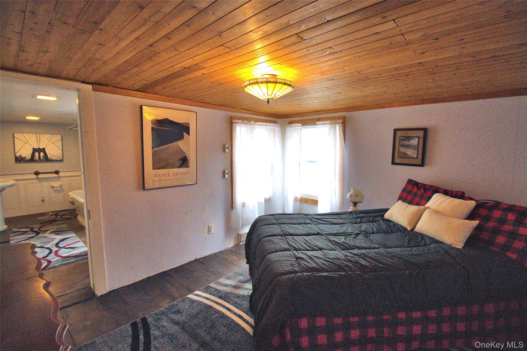 7 State Rte 55 Napanoch, NY 12458 - Photo 21 of 38 a bedroom with a bed and a chandelier