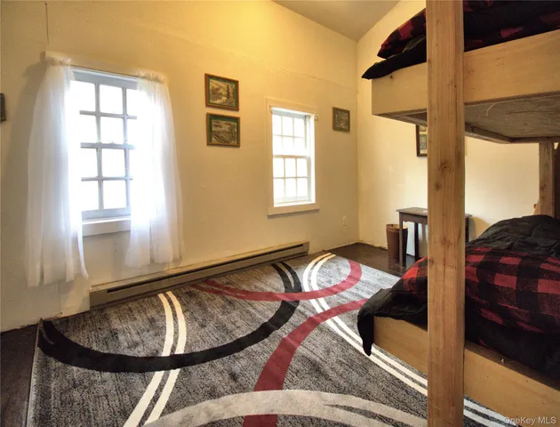 a bed sitting in a bedroom next to a window