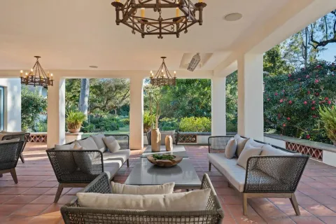 a view of a chairs and table in the backyard