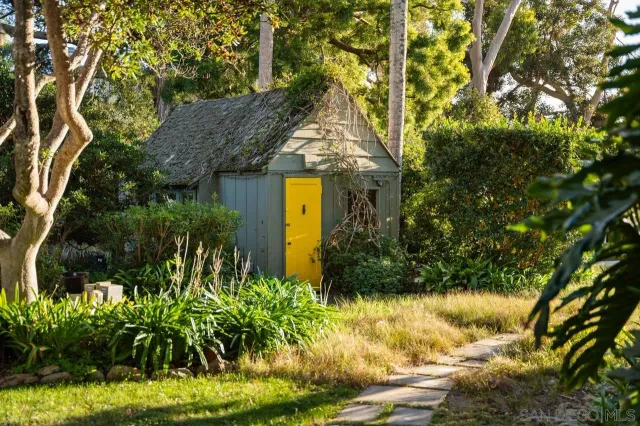 a living room with furniture a chandelier and a fireplace