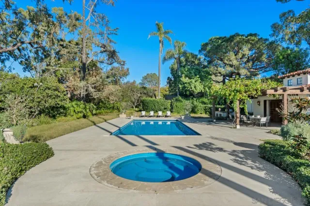 a kitchen with a stove a refrigerator and wooden floor