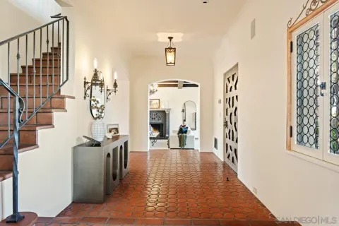 a dining room with a glass top table and chairs