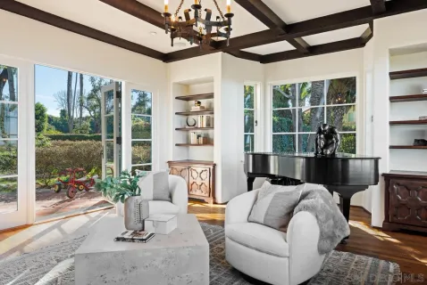 a living room with furniture and a painting on the wall