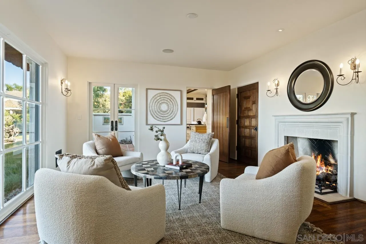 1205 Muirlands Drive La Jolla, CA 92037 - Photo 33 of 75 a living room with furniture a fireplace and a window