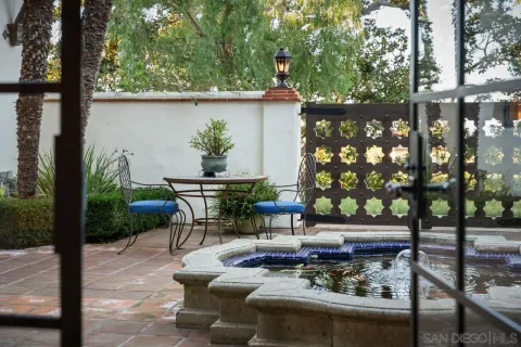 a bathroom with a granite countertop sink and a bathtub