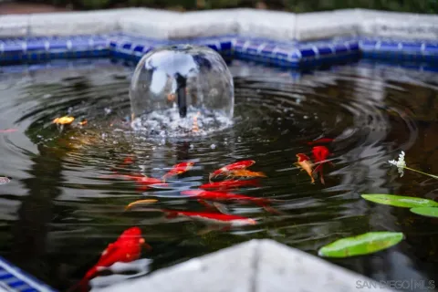 a bathroom with white cabinets and a mirror