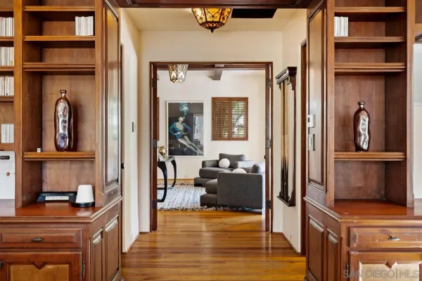 a view of an empty room with a window and sitting area