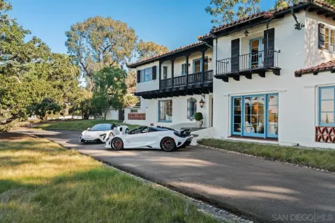 a living room with furniture and floor to ceiling windows