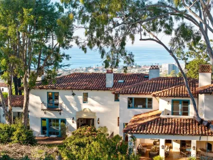 a front view of a house with a yard with plants