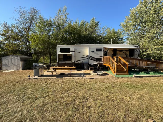 a backyard of a house with table and chairs