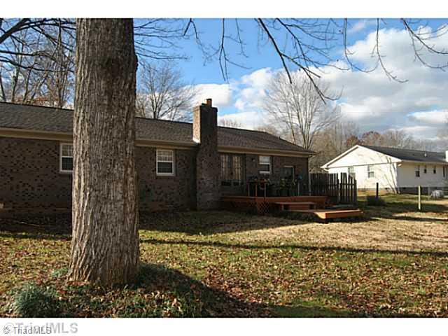 715 Laverton Lane Rural Hall, NC 27045 - Photo 14 of 15 Exterior Back. all brick home with a deck, fenced back yard