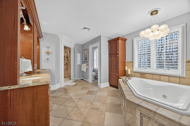 14 Jenny Layne Road Vernon, NJ 07461 - Photo 22 of 42 a bathroom with a tub sink and mirror