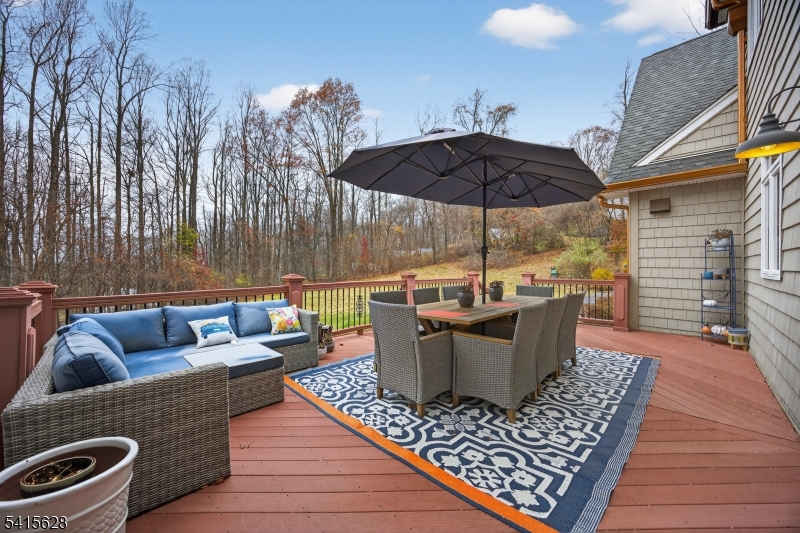 14 Jenny Layne Road Vernon, NJ 07461 - Photo 32 of 42 a view of a roof deck with couches fire pit and wooden floor