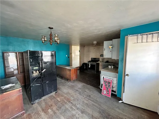 a kitchen with refrigerator and microwave