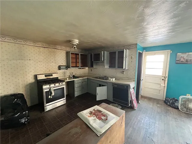 a kitchen with a sink appliances and cabinets