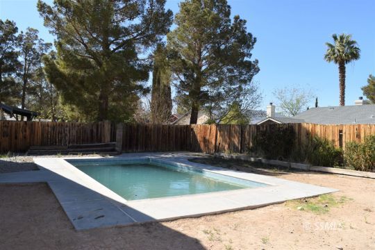 1132 West Robert Avenue Ridgecrest, CA 93555 - Photo 37 of 38 a view of a backyard with a small pool