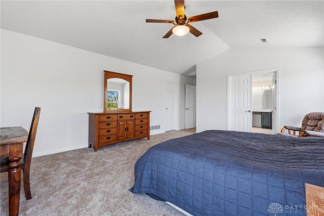 70 Martin Lane Springboro, OH 45066 - Photo 37 of 69 This spacious primary bedroom features carpeted flooring and an adjacent private bathroom.