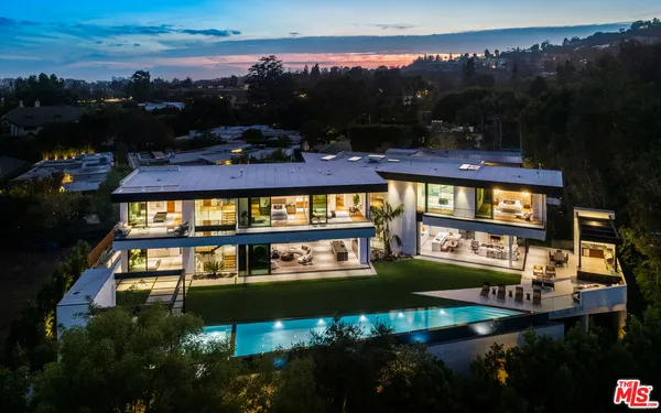 an aerial view of a house swimming pool patio and outdoor seating
