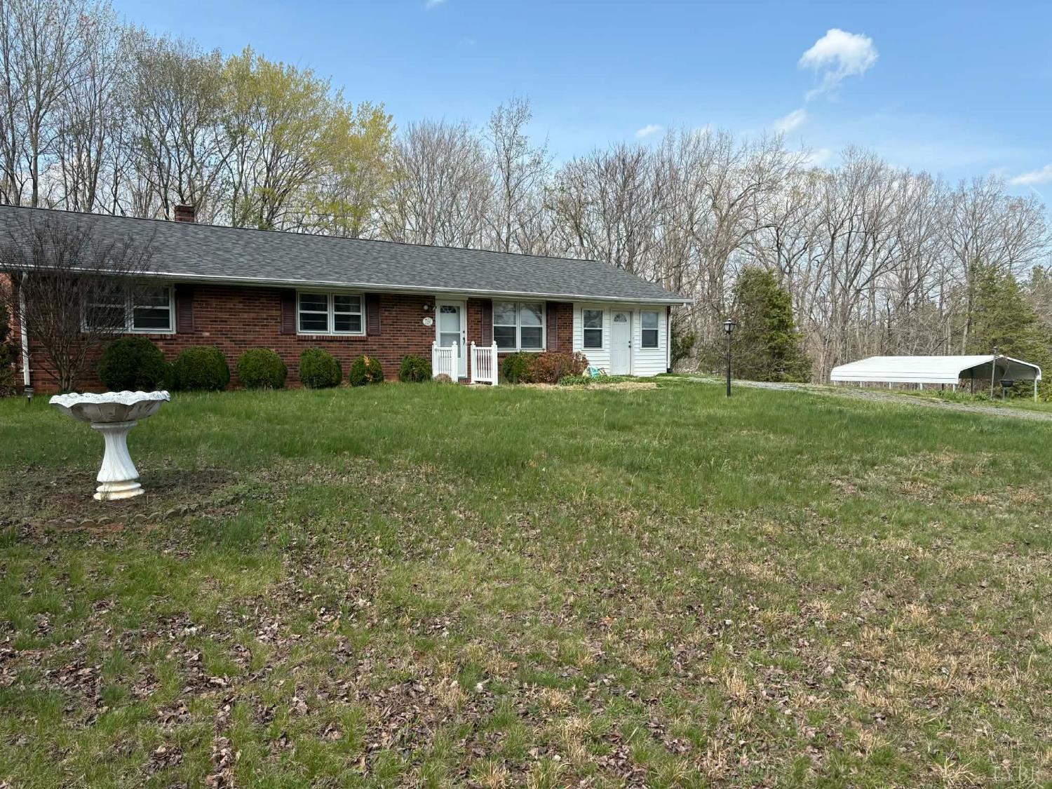 a front view of a house with a garden and trees