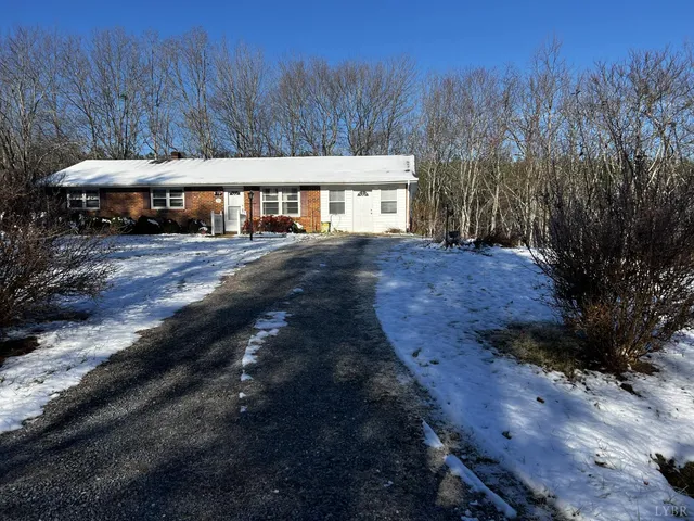 a view of house with yard and trees