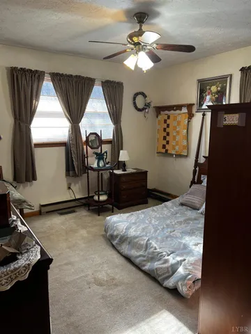 a bedroom with a bed dresser and a window
