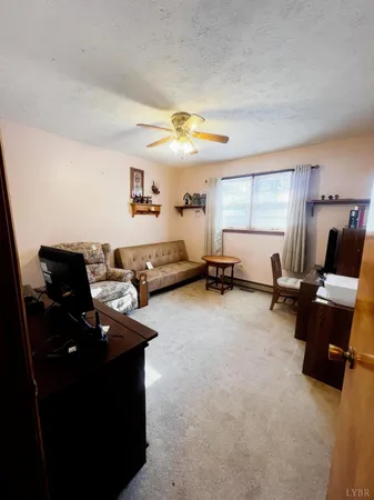 a living room with furniture gym equipment and a window