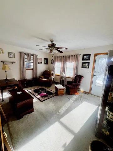 a living room with furniture gym equipment and a window