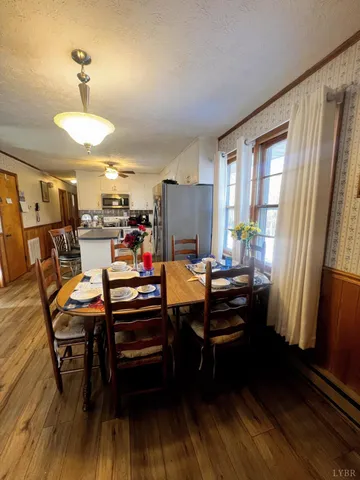 a view of a dining room with furniture window and wooden floor