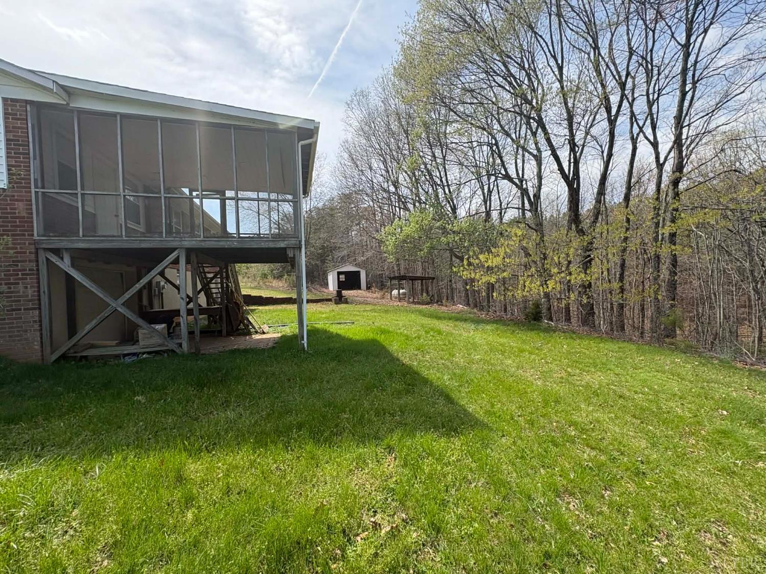 1796 Owens Mill Road Gretna, VA 24557 - Photo 10 of 24 a view of a backyard with a small cabin and a chair
