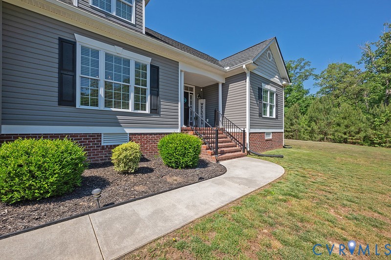 9425 Marie Road New Kent, VA 23124 - Photo 36 of 55 a front view of a house with garden