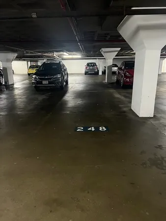 a view of parking garage with cars