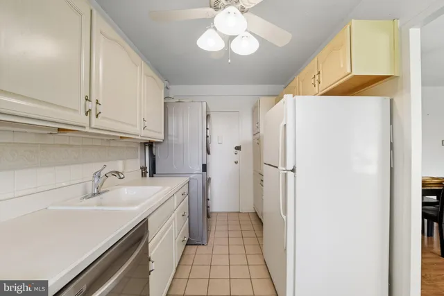 a kitchen with a sink appliances and cabinets