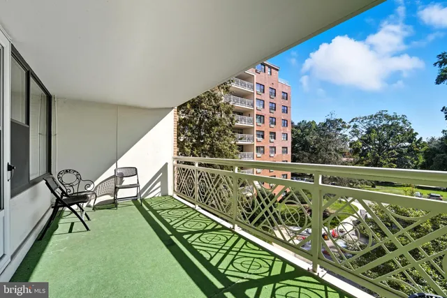 a view of a chairs and table on the balcony