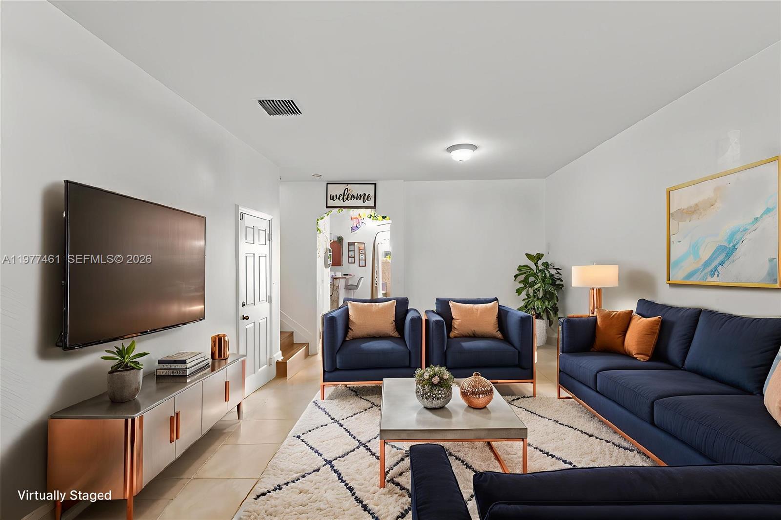 12958 Southwest 135th Street Miami, FL 33186 - Photo 2 of 14 a living room with furniture and a flat screen tv