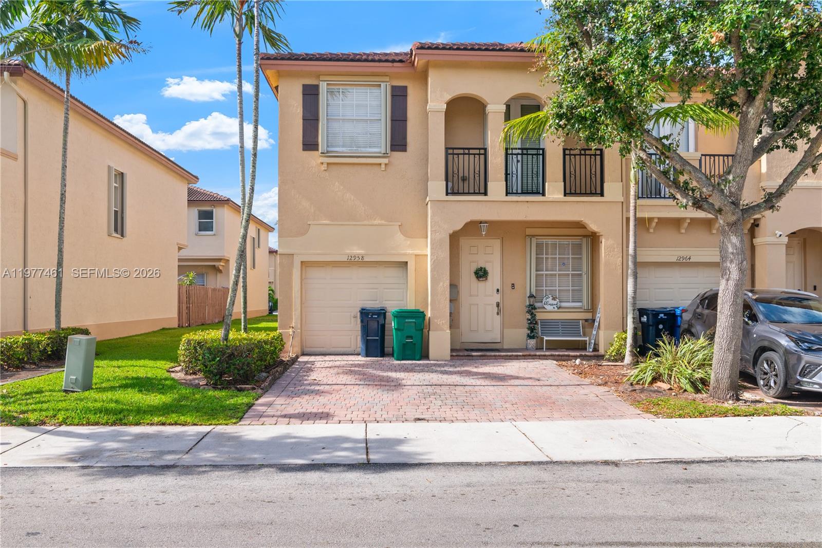 12958 Southwest 135th Street Miami, FL 33186 - Photo 4 of 14 a front view of a house with a garden and plants