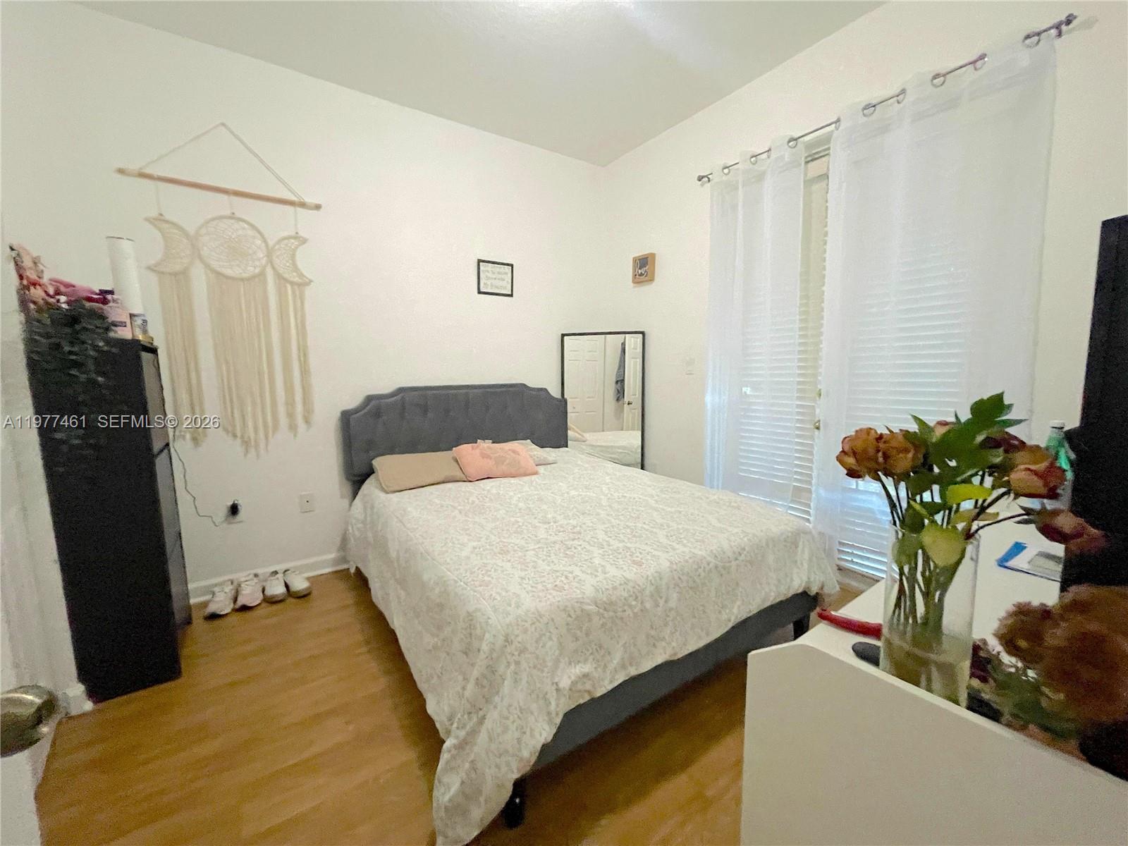 12958 Southwest 135th Street Miami, FL 33186 - Photo 10 of 14 a bedroom with a bed and a potted plant