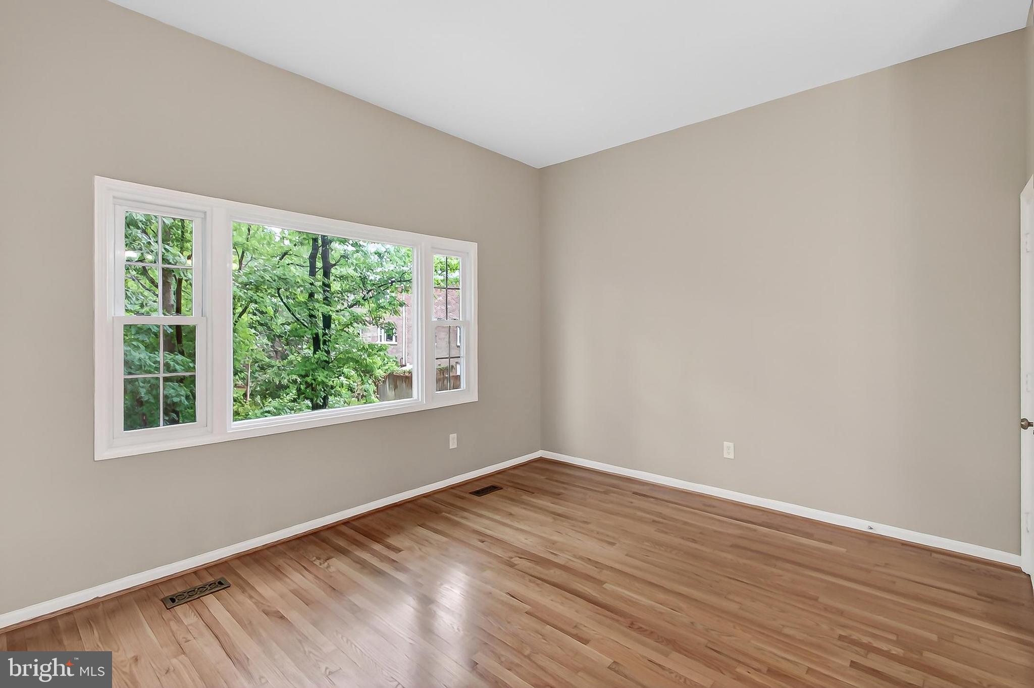 5833 Royal Ridge Drive, Unit 943 Springfield, VA 22152 - Photo 8 of 45 a view of empty room with wooden floor and fan