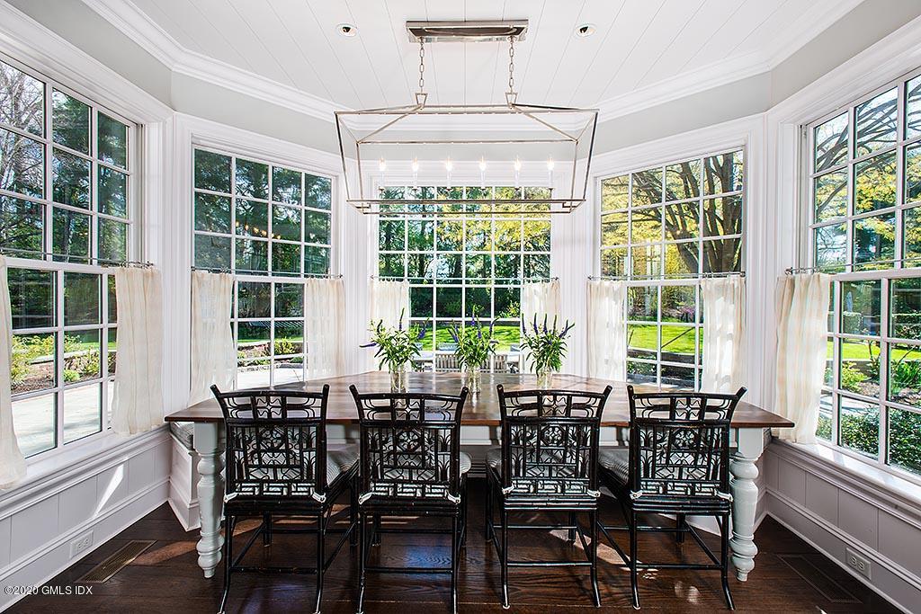 27 Midwood Road Greenwich, CT 06830 - Photo 11 of 30 a view of a dining room with furniture large windows and wooden floor