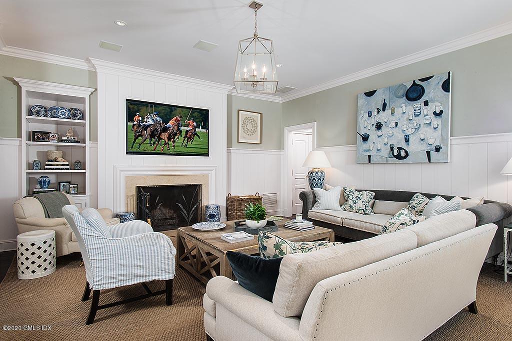 27 Midwood Road Greenwich, CT 06830 - Photo 13 of 30 a living room with furniture a fireplace and wall paintings