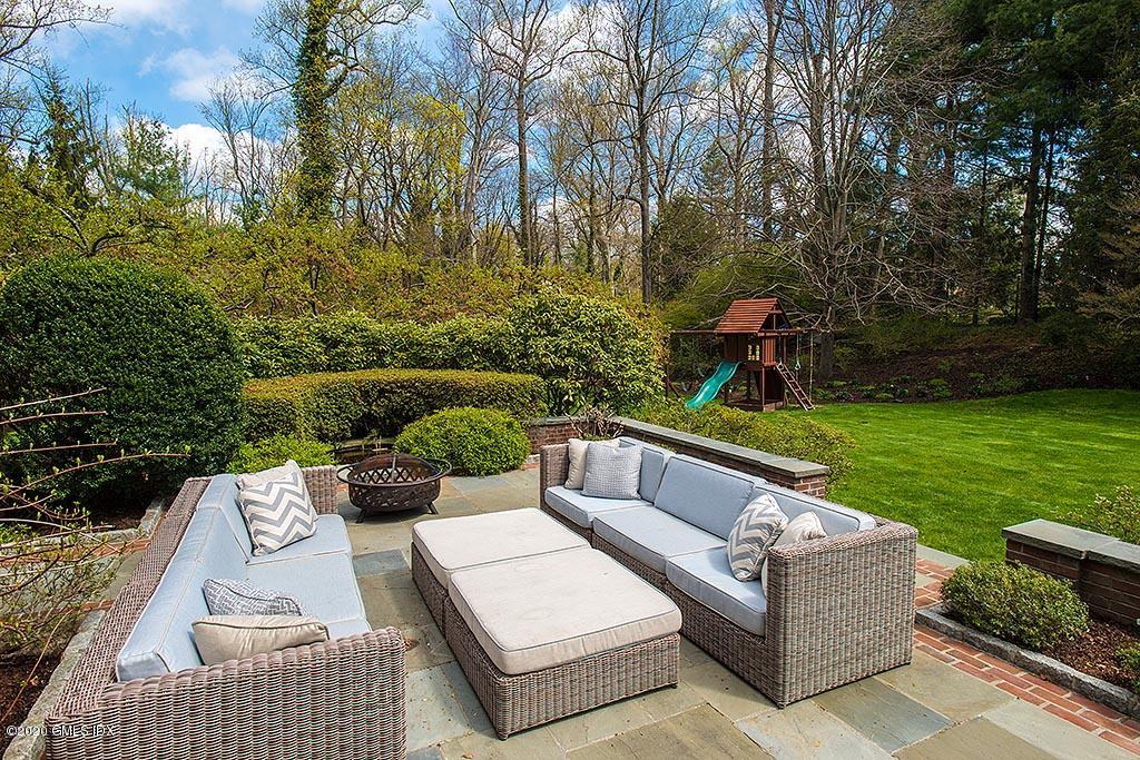 27 Midwood Road Greenwich, CT 06830 - Photo 21 of 30 a view of a patio with couches table and chairs with potted plants and large trees
