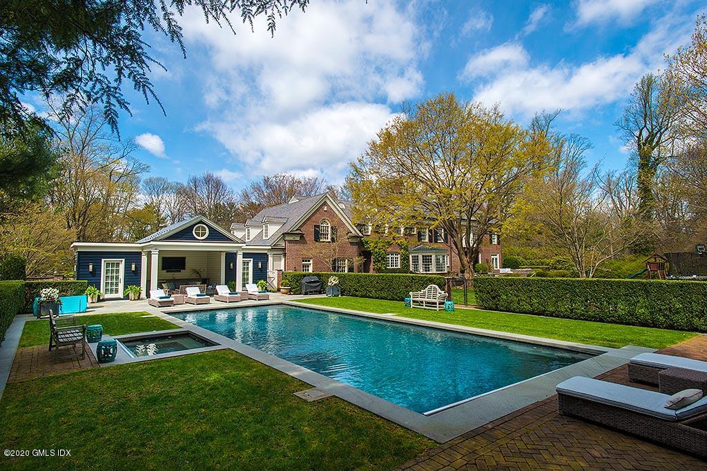 27 Midwood Road Greenwich, CT 06830 - Photo 22 of 30 a view of an house with swimming pool and yard