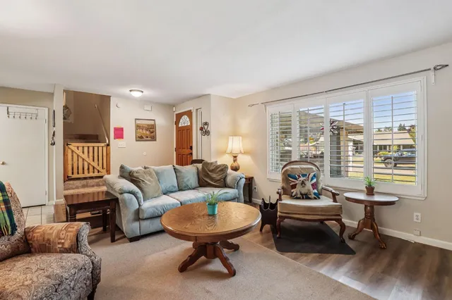 a dining room with furniture a chandelier and wooden floor