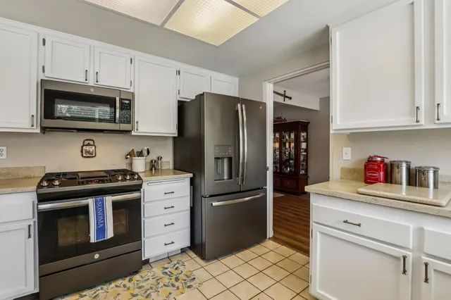 a kitchen that has a sink and a stove in it