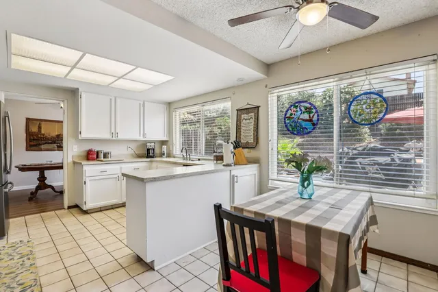 a kitchen with granite countertop a sink appliances and cabinets